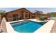 Beautiful backyard with a sparkling pool, hot tub, and patio area at 25840 W Whyman St, Buckeye, AZ 85326