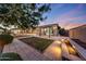 Well-maintained backyard with a tiled patio, a stone-edged pool, and landscaped areas at 26204 S Washington St, Chandler, AZ 85249