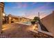 Extensive backyard features a private pool, a covered patio, and custom stone detailing at 26204 S Washington St, Chandler, AZ 85249