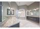 Luxurious bathroom with marble countertops, dual vanities, and a soaking tub with elegant tile surround at 26204 S Washington St, Chandler, AZ 85249