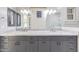 A bathroom with granite counters, dual sinks, large mirrors and custom cabinetry at 26204 S Washington St, Chandler, AZ 85249