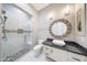 A bathroom showcasing a frameless glass shower, granite counters and updated fixtures at 26204 S Washington St, Chandler, AZ 85249