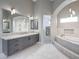 Elegant bathroom featuring marble countertops, custom cabinets, soaking tub, and walk-in shower at 26204 S Washington St, Chandler, AZ 85249