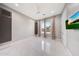 Stylish bedroom features white marble floors, a ceiling fan, and mounted TV at 26204 S Washington St, Chandler, AZ 85249