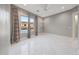 Bright bedroom featuring white marble floors, a ceiling fan, and neutral-toned walls at 26204 S Washington St, Chandler, AZ 85249