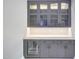 Close up view of gray cabinets with glass doors, drawers and wine cooler at 26204 S Washington St, Chandler, AZ 85249
