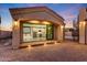 The exterior view of a home with outdoor lighting, a modern kitchen, and a staircase at 26204 S Washington St, Chandler, AZ 85249