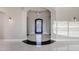 Elegant foyer with decorative front door, arched entryway, and modern lighting at 26204 S Washington St, Chandler, AZ 85249