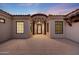 Home's front entrance featuring a turret, decorative iron door, and a brick-paved walkway at 26204 S Washington St, Chandler, AZ 85249