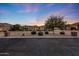 Inviting front exterior showcases lush landscaping and a circular driveway at dusk at 26204 S Washington St, Chandler, AZ 85249