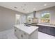 Kitchen features a large central island, stainless steel appliances, and mosaic tile backsplash at 26204 S Washington St, Chandler, AZ 85249
