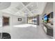 Bright and spacious living room with modern finishes, coffered ceiling, and access to the patio at 26204 S Washington St, Chandler, AZ 85249