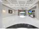 Open living room featuring bright marble floors, coffered ceilings, and sliding glass doors at 26204 S Washington St, Chandler, AZ 85249