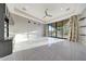 Spacious living room with marble floors, ceiling fan, and sliding glass doors leading to the backyard at 26204 S Washington St, Chandler, AZ 85249