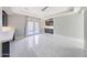 Bright living room with gray cabinets, marble floors and French doors to the backyard at 26204 S Washington St, Chandler, AZ 85249