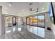 Spacious living room featuring modern tile floors, recessed lighting, and a sliding glass door to the pool at 26204 S Washington St, Chandler, AZ 85249