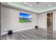 Finished media room featuring a flat screen, modern lighting, and tile floors at 26204 S Washington St, Chandler, AZ 85249