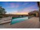 Captivating pool area with a step-down entry, ambient lighting, and stylish patio tiles at 26204 S Washington St, Chandler, AZ 85249