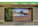 A view of the pool and patio with outdoor kitchen through sliding glass doors from the interior at 26204 S Washington St, Chandler, AZ 85249