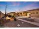 An outdoor swimming pool with lights, covered patios, and desert landscaping at 26204 S Washington St, Chandler, AZ 85249