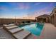 An outdoor swimming pool with steps and desert landscaping at 26204 S Washington St, Chandler, AZ 85249