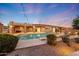An outdoor pool with desert landscaping, covered patios, and string lights at 26204 S Washington St, Chandler, AZ 85249
