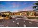 An outdoor swimming pool with lights, covered patios, and desert landscaping at 26204 S Washington St, Chandler, AZ 85249
