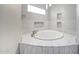 Tranquil soaking tub area with marble tile, providing a serene and relaxing retreat at 26204 S Washington St, Chandler, AZ 85249
