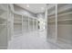 Expansive walk-in closet featuring custom built-in shelving, marble floors, and ample storage space at 26204 S Washington St, Chandler, AZ 85249