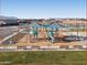 Aerial view of a community playground featuring sunshades, slides, and convenient benches at 36859 W Santa Maria St, Maricopa, AZ 85138