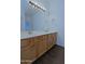 Bathroom with double sink vanity with a large mirror and decorative lighting fixture at 38065 N Cave Creek Rd # 2, Cave Creek, AZ 85331