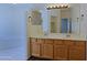 Bathroom featuring a double vanity with a large mirror and a soaking tub in the background at 38065 N Cave Creek Rd # 2, Cave Creek, AZ 85331