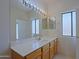 Bathroom with vanity, large mirror with lights, and a window at 38065 N Cave Creek Rd # 2, Cave Creek, AZ 85331