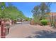 Community entrance featuring brick paved road, desert landscaping, and a security gate at 38065 N Cave Creek Rd # 2, Cave Creek, AZ 85331
