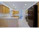 Spacious kitchen with black appliances, white countertops, and wood cabinets at 38065 N Cave Creek Rd # 2, Cave Creek, AZ 85331