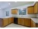 Kitchen featuring black appliances, white countertops, and wood cabinets at 38065 N Cave Creek Rd # 2, Cave Creek, AZ 85331