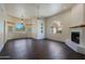 Inviting living room featuring hardwood floors, arched windows, and cozy fireplace at 38065 N Cave Creek Rd # 2, Cave Creek, AZ 85331