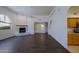 Open-concept living area with fireplace, hardwood flooring, and seamless transition to kitchen at 38065 N Cave Creek Rd # 2, Cave Creek, AZ 85331