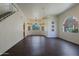 Spacious living room with hardwood floors, arched windows, and staircase at 38065 N Cave Creek Rd # 2, Cave Creek, AZ 85331