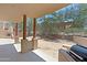 Covered patio with wooden pillars with a built in grill and views of the desert landscape at 38065 N Cave Creek Rd # 2, Cave Creek, AZ 85331
