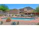 Community pool with desert landscaping, lounge chairs, and mountain views at 38065 N Cave Creek Rd # 2, Cave Creek, AZ 85331