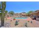 Community pool featuring desert landscaping, poolside seating, and mountain views at 38065 N Cave Creek Rd # 2, Cave Creek, AZ 85331