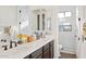 Bathroom featuring a double vanity with white countertops, undermount sinks, and a tiled walk-in shower enclosure at 3917 E Patrick Ln, Phoenix, AZ 85050