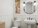 Well-lit half-bathroom with a round mirror and vintage style vanity at 3917 E Patrick Ln, Phoenix, AZ 85050