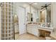 Bathroom with glass block wall, white cabinetry, and large mirror at 3917 E Patrick Ln, Phoenix, AZ 85050