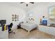Bright bedroom with a ceiling fan, travertine floors, ample natural light, and decorated with assorted memorabilia at 3917 E Patrick Ln, Phoenix, AZ 85050