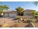 Charming home with a three-car garage, desert landscaping, and a tile roof at 3917 E Patrick Ln, Phoenix, AZ 85050