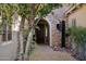 Inviting front entrance with a stone facade, arched doorway, and decorative cactus at 3917 E Patrick Ln, Phoenix, AZ 85050