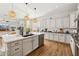 Modern white kitchen featuring a large island, stainless steel appliances, and open layout at 3917 E Patrick Ln, Phoenix, AZ 85050