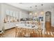 Sunlit kitchen with white cabinets, large island with seating, and modern decor at 3917 E Patrick Ln, Phoenix, AZ 85050